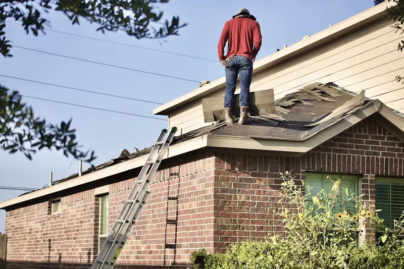 Professional roofer working on a residential roof in Breezy Knolls Estates